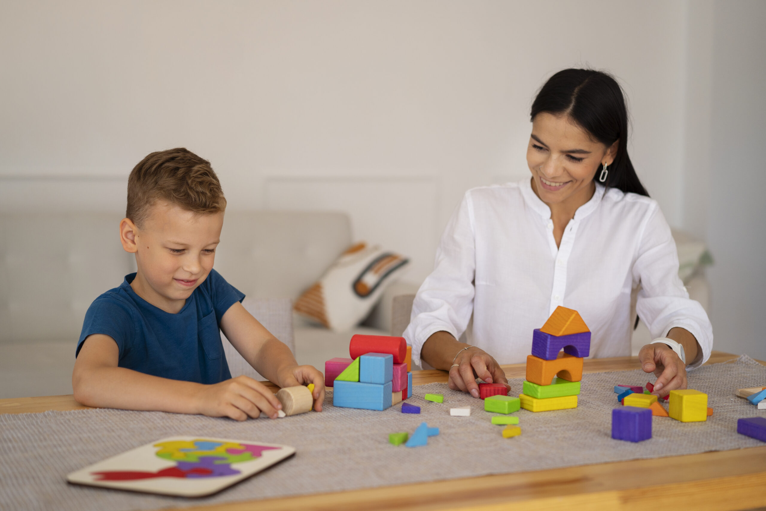 A kid using colorful educational blocks during a therapy session